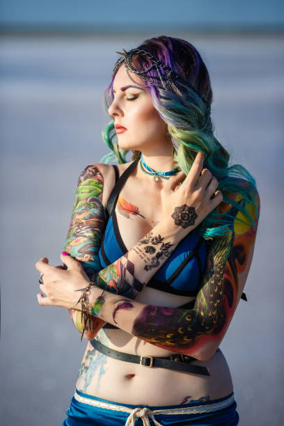 Woman with colorful hair and full-sleeve tattoos ink