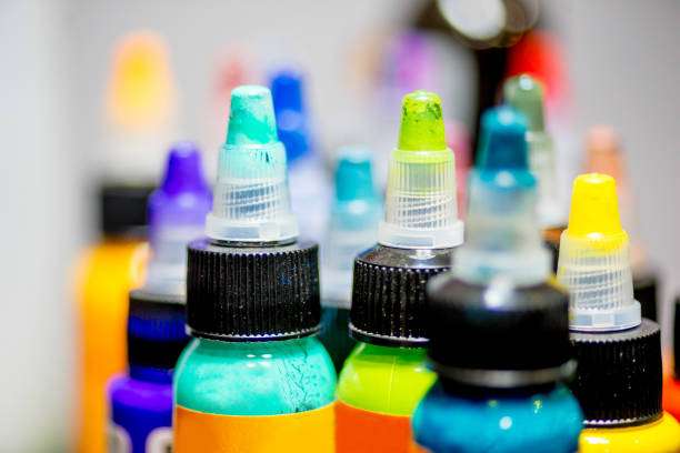 A vibrant array of colorful tattoo ink bottles, showcasing diverse shades for artists.